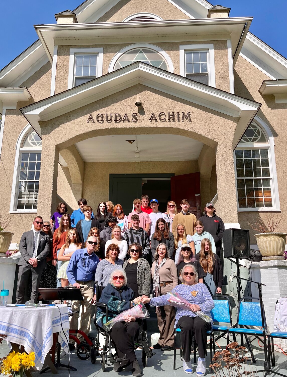 Holocaust survivors Marlene Wertheim,left, and Eva Bocskor, both seated, shared their stories with Livingston Manor high school students and others at the Temple Agudas Achim Daffodil Project garden ceremony.